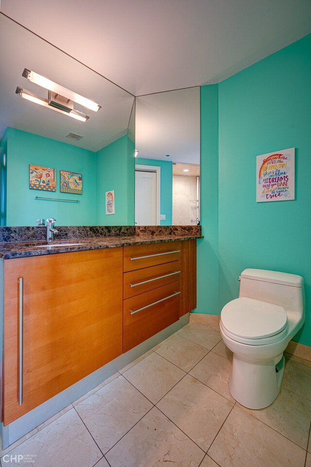 bathroom with visible vents, toilet, marble finish floor, and vanity