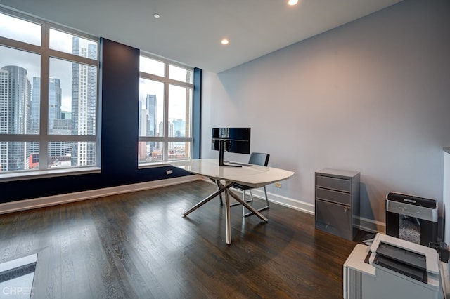 office with dark wood finished floors, a view of city, recessed lighting, and baseboards