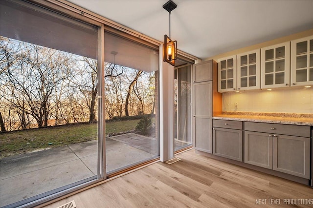 unfurnished dining area featuring light wood finished floors