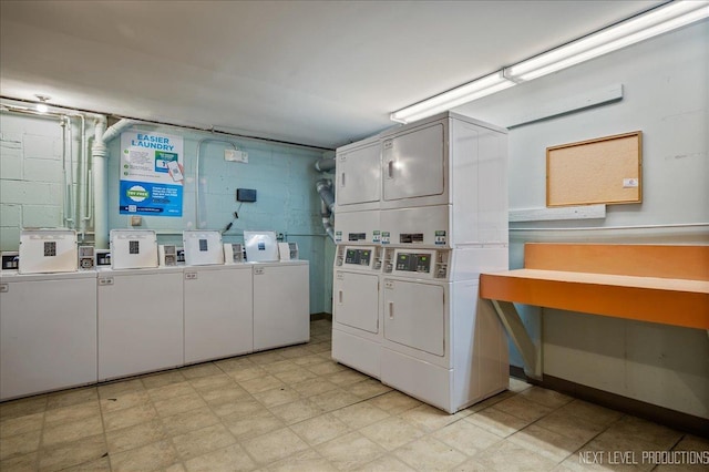 shared laundry area with light floors, independent washer and dryer, stacked washer and clothes dryer, and concrete block wall