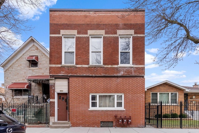 view of front facade featuring stone siding, a fenced front yard, and brick siding