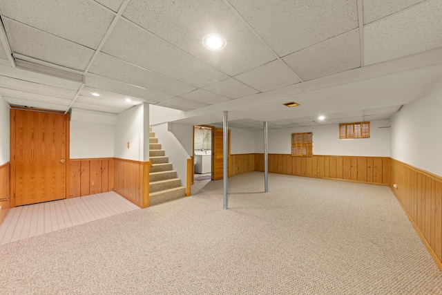 finished basement featuring carpet floors, recessed lighting, stairway, wainscoting, and wooden walls