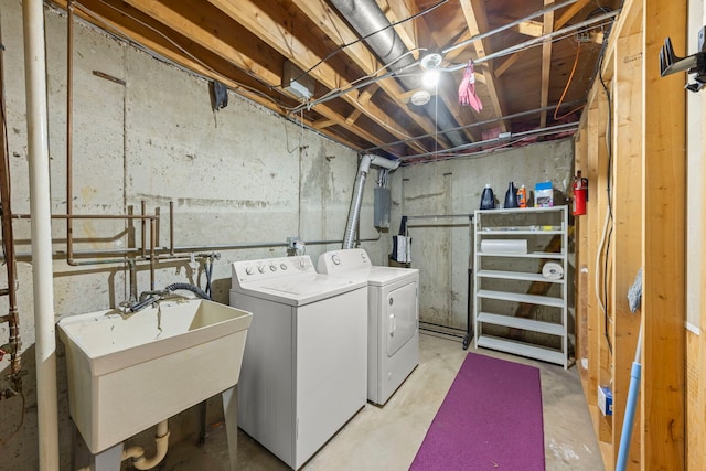 laundry area with laundry area, washer and clothes dryer, and a sink