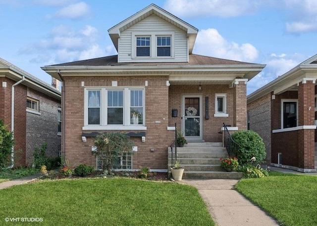 view of front of house featuring brick siding and a front lawn