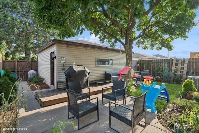 view of patio / terrace with central air condition unit, a fenced backyard, grilling area, and an outdoor living space