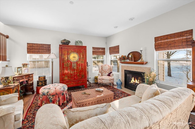 living room featuring a tile fireplace