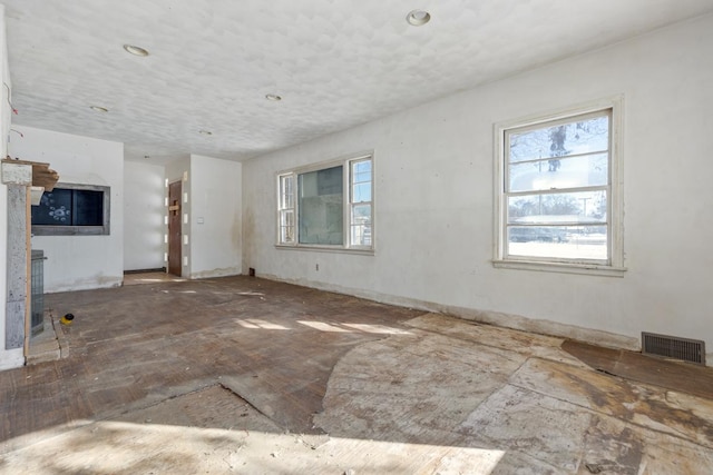 unfurnished living room featuring visible vents