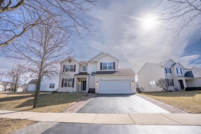 traditional home with a garage, driveway, and a front lawn