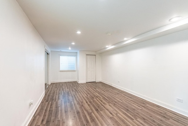 empty room with recessed lighting, wood finished floors, and baseboards