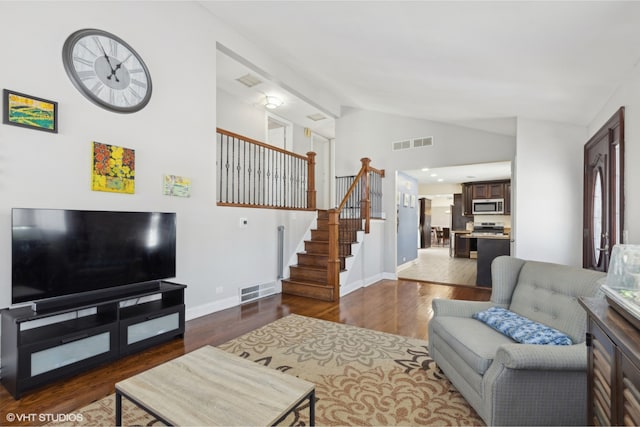 living area featuring dark wood-style flooring, visible vents, stairway, and baseboards