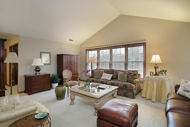 living room featuring visible vents, high vaulted ceiling, and light colored carpet