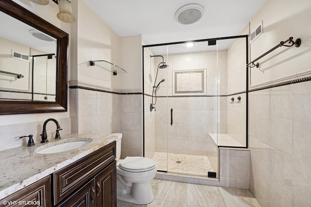 full bathroom with toilet, a stall shower, visible vents, and tile walls