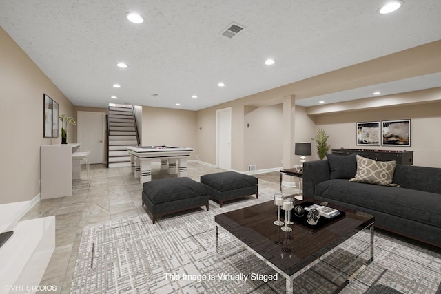 living area with recessed lighting, baseboards, and stairs