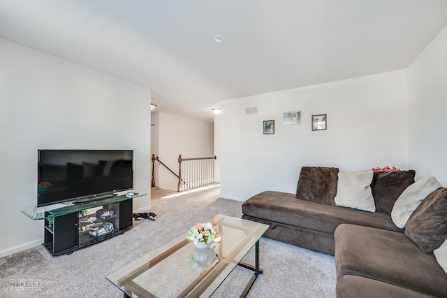 living room featuring light carpet, visible vents, and baseboards