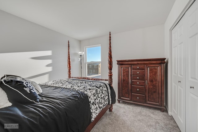 bedroom with light carpet and a closet