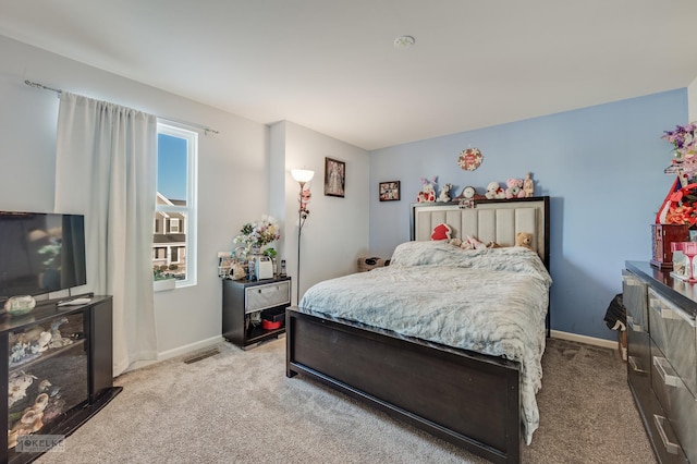 bedroom featuring light colored carpet and baseboards