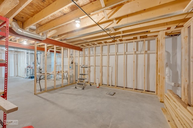 unfinished basement featuring water heater