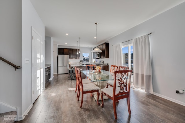 dining area featuring stairs, baseboards, dark wood-type flooring, and recessed lighting