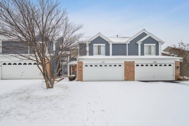 traditional home with a garage and brick siding