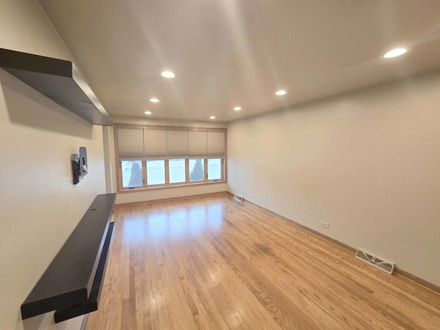 unfurnished room featuring light wood-type flooring, visible vents, and recessed lighting