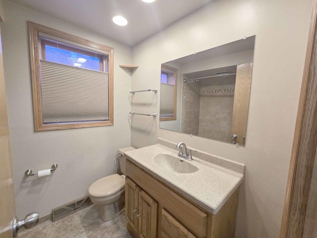 bathroom with baseboards, visible vents, vanity, and toilet