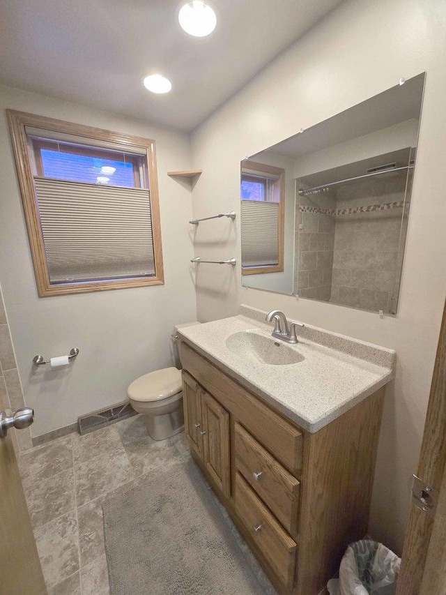 bathroom featuring toilet, visible vents, and vanity