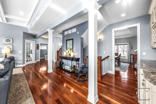 interior space with dark wood-style floors, decorative columns, stairway, and baseboards