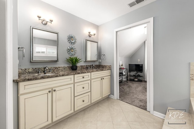 bathroom with double vanity, tile patterned flooring, visible vents, and a sink