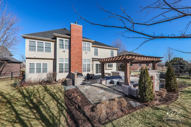 back of house with a patio, fence, a yard, a pergola, and a chimney