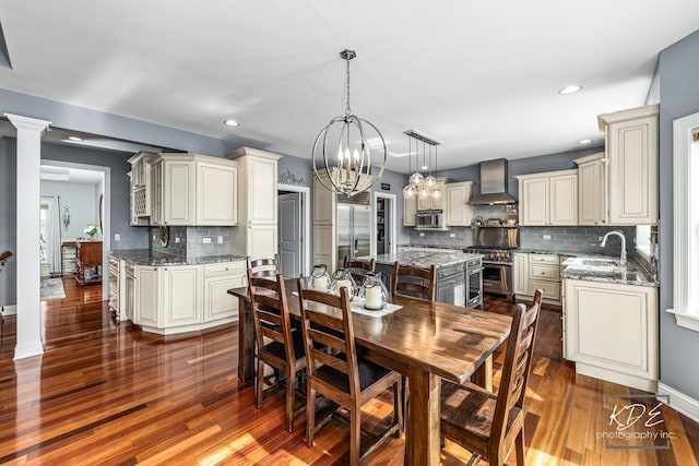 dining space featuring dark wood-type flooring, recessed lighting, and an inviting chandelier