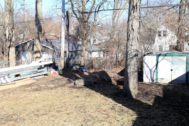 view of yard featuring a storage shed and an outdoor structure