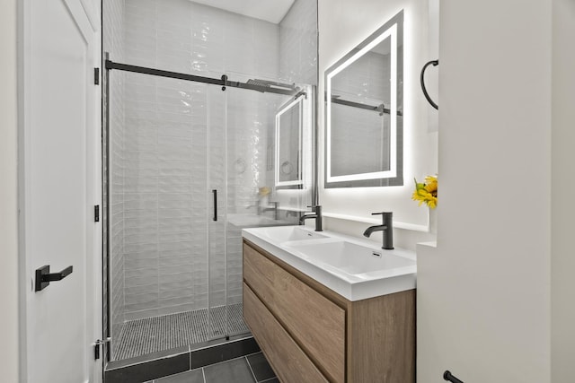 full bath featuring double vanity, tile patterned flooring, a shower stall, and a sink