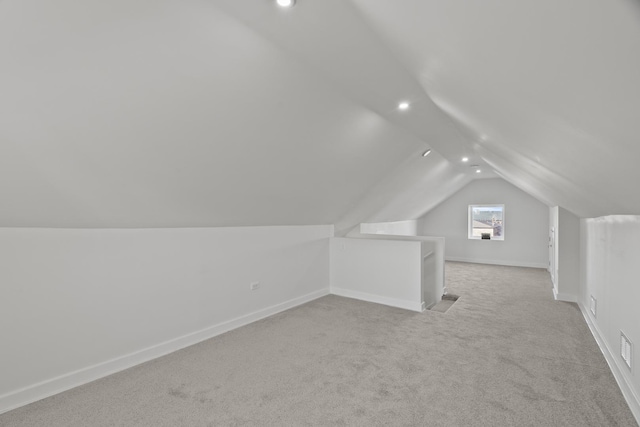 bonus room with recessed lighting, baseboards, vaulted ceiling, and light colored carpet