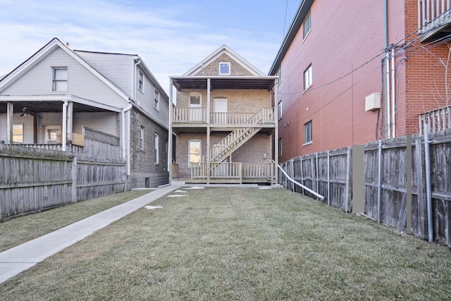 view of yard featuring stairway and fence