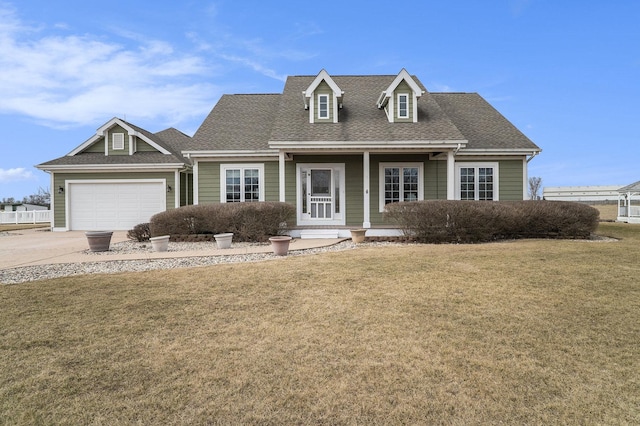 new england style home featuring driveway, roof with shingles, an attached garage, covered porch, and a front lawn