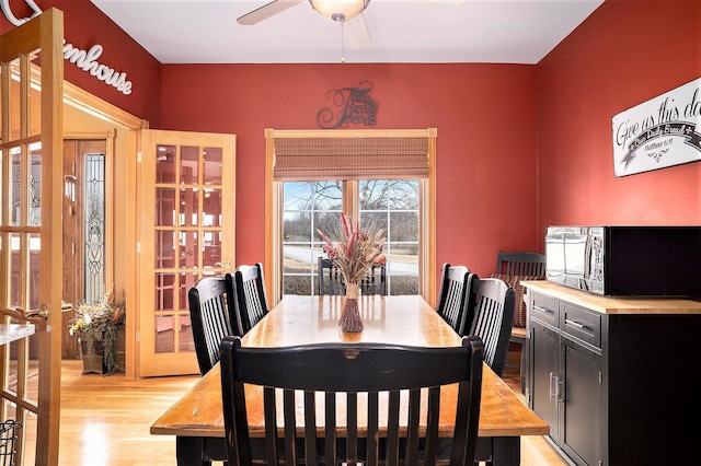 dining room featuring a ceiling fan and light wood-style flooring