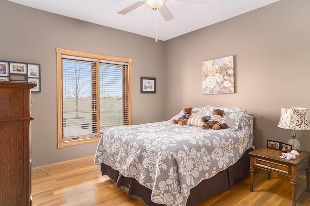 bedroom with a ceiling fan and light wood-type flooring