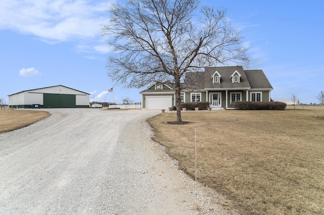 view of front of house with driveway and a front lawn