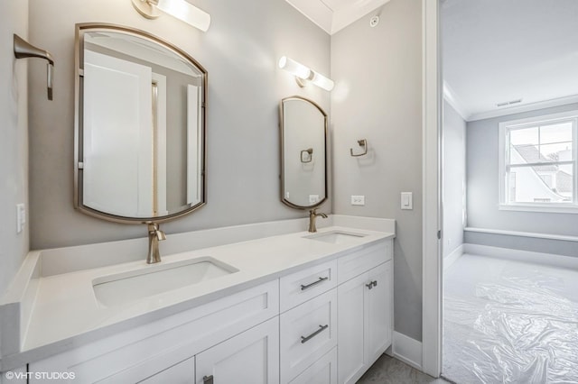 full bathroom with double vanity, a sink, visible vents, and crown molding