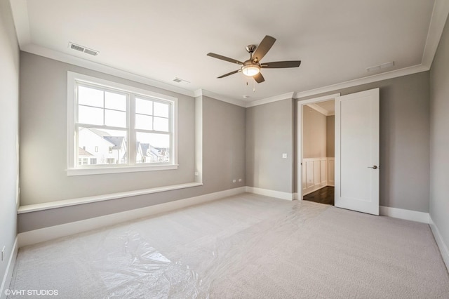 unfurnished bedroom featuring ornamental molding, carpet, visible vents, and baseboards