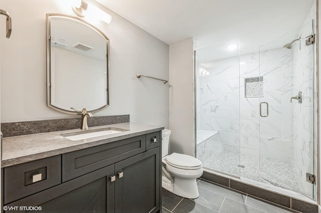 bathroom with a marble finish shower, visible vents, toilet, tile patterned flooring, and vanity