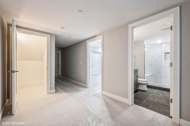 hallway with carpet and baseboards