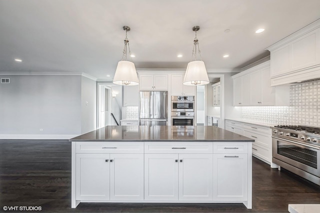 kitchen with appliances with stainless steel finishes, dark countertops, and white cabinets