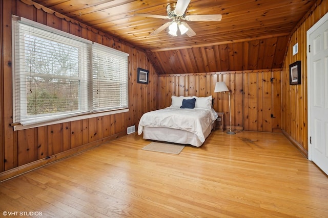 bedroom featuring wooden ceiling, light wood-type flooring, lofted ceiling, and visible vents