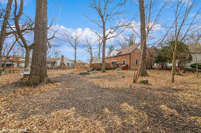 view of yard featuring a deck and fence