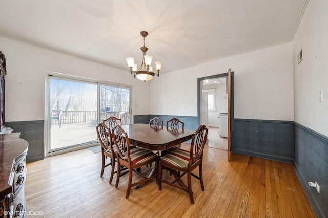 dining room featuring a wainscoted wall, visible vents, a wealth of natural light, and light wood-style floors