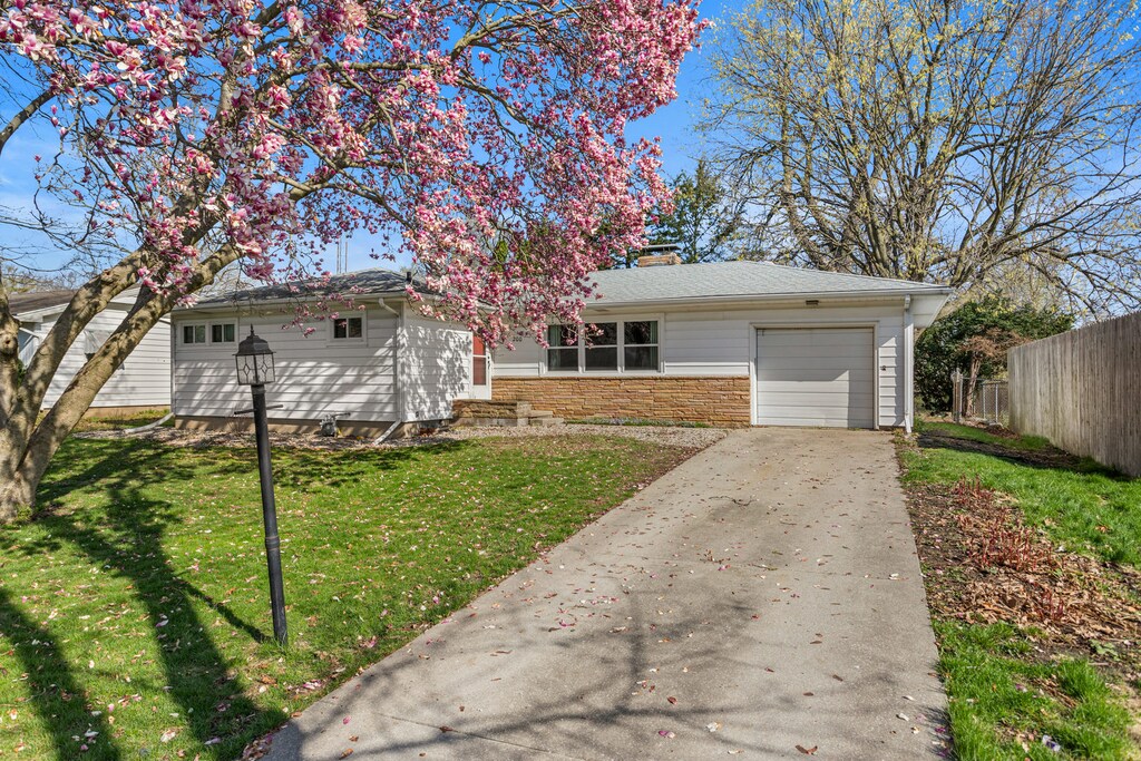 200 Buena Vista Dr, Champaign, IL 61820 - ranch-style home featuring an attached garage, a chimney, fence, concrete driveway, and a front lawn