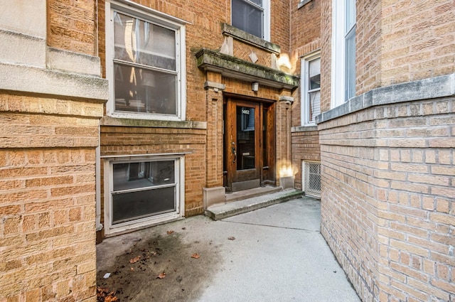 doorway to property with brick siding