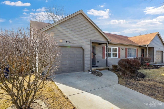 single story home with a garage and concrete driveway