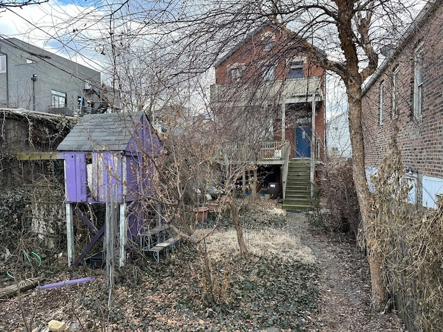 view of yard with stairs and an outbuilding